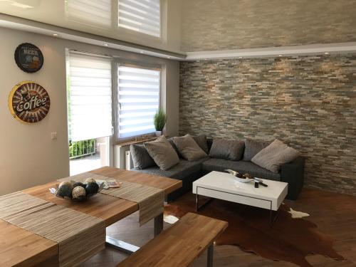 a living room with a couch and a table at Ermmes Ferienwohnungen in Sinsheim