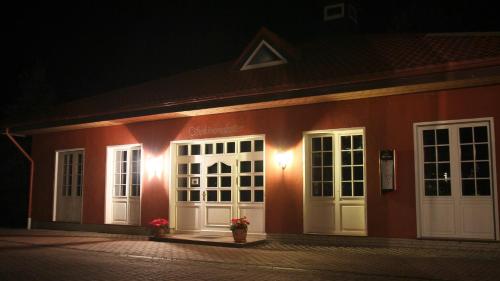 a red building with white doors at night at Wellnesshotel Legde in Legde