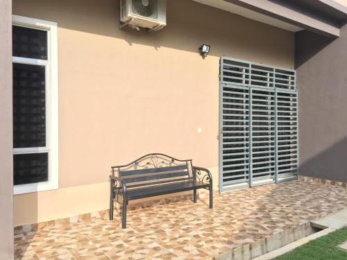 a bench sitting in front of a house at Ana Guest House Jalan Airport Kuantan in Kuantan
