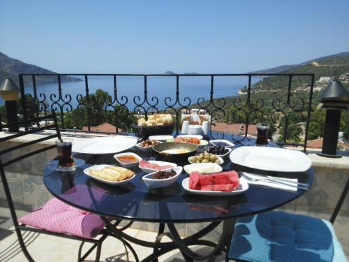 a table with bowls of food on a balcony at Enda Boutique Hotel Kalkan in Kalkan