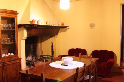 a dining room with a table and a fireplace at Villa del Cardinale in Spoleto