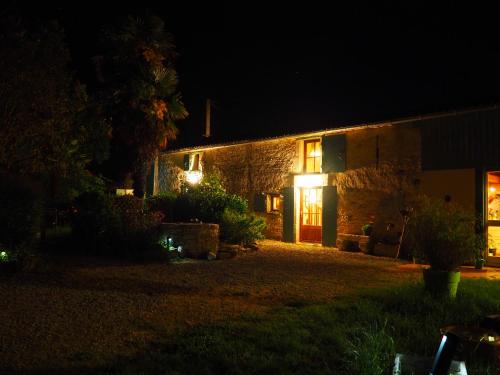 a house with lights on the side of it at night at Des Km à La Ronde in La Ronde