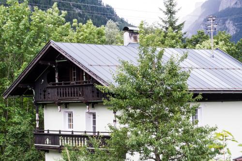 a white house with a metal roof at Haus Loferer in Sankt Martin bei Lofer