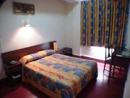 Una cama o camas en una habitación de Hotel 5a Avenida