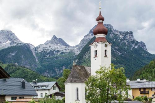 a church with a mountain in the background at Haus Loferer in Sankt Martin bei Lofer