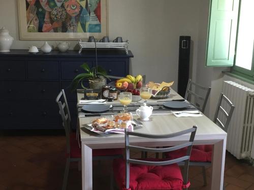 a table with a plate of food on it at Appartamento Il Glicine in Pistoia