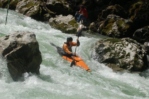 a man in an orange kayak in a river at Haus Loferer in Sankt Martin bei Lofer