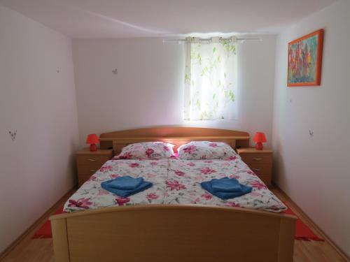 a bedroom with a bed with blue pillows on it at Apartma Patricija - cozy apartments in Tolmin