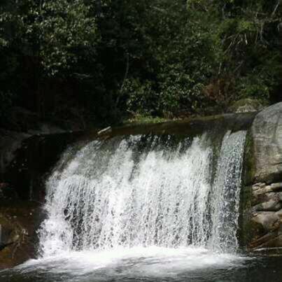 a waterfall in the middle of a river at Hotel Rural Carlos I in Garganta la Olla