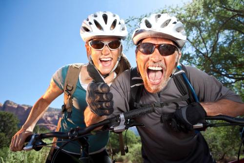 two people wearing helmets are holding a bike at Casa de Tres Lunas/House of Three Moons in Santa Fe