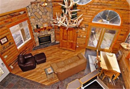 a living room with a couch and a fireplace at Zion Ponderosa Ranch Resort in Springdale