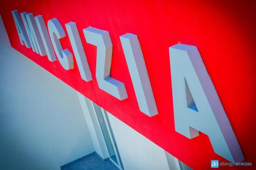 a red sign with the word finishaza on it at Hotel Amicizia in Rimini