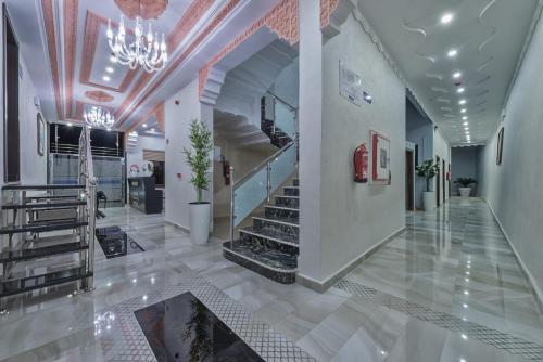 a lobby with stairs and a chandelier at Hotel Jibal Chaouen in Chefchaouen