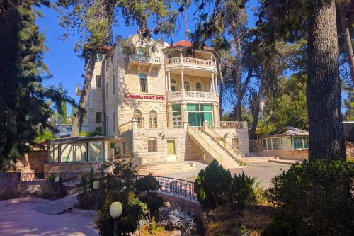 an image of a large house with trees at Alhambra Palace Hotel Suites - Ramallah in Ramallah