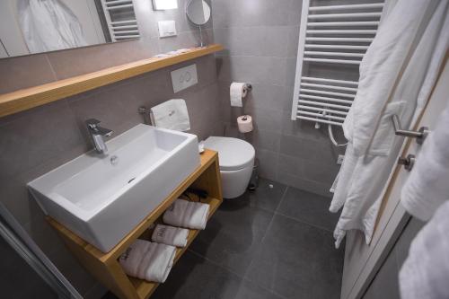 a bathroom with a sink and a toilet at Mijama suites in Split