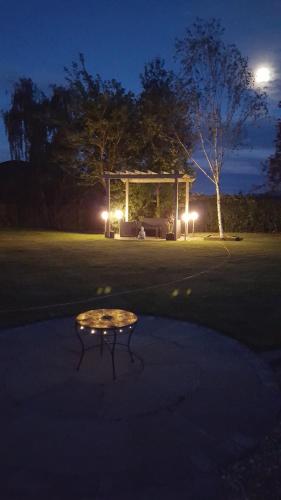 a table in front of a gazebo at night at Ruth's Rest Country Retreat with private Hot Tub in Shrewsbury