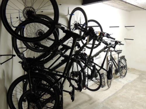 two bikes are hanging from a bike rack at Hotel Restaurant du Parc en Bord de Rivière in Fontaine-de-Vaucluse