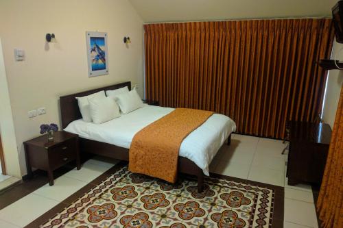 a hotel room with a bed and a large window at Alhambra Palace Hotel Suites - Ramallah in Ramallah