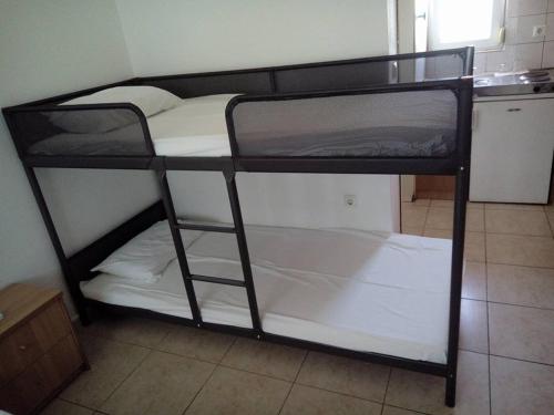 a couple of bunk beds in a room at Studios Kapsalas in Néa Michanióna