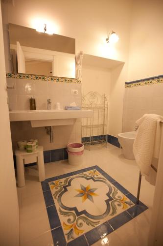 a bathroom with a sink and a toilet at Italiana Resort Maniace in Syracuse