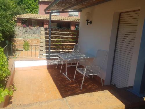 a table and chairs sitting on a patio at Hostal Ondina in Begur