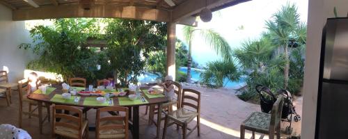 a table with food on it in a patio at Villa Maria Bed and Breakfast in Puerto Escondido