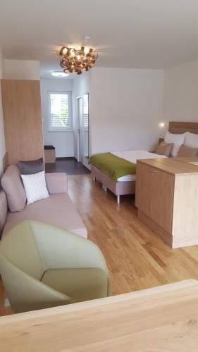 a living room with a bed and a couch at Zegg-Lounge in Seeboden