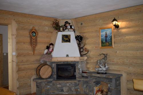a fireplace in a room with wooden walls at U Wajdy in Małe Ciche