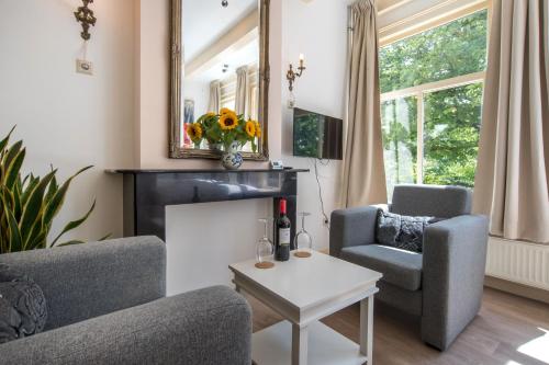 a living room with two chairs and a fireplace at The Blue Stairs in Amsterdam
