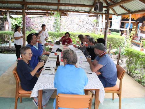 a group of people sitting at a long table at Suymar Ecolodge Galapagos in Puerto Ayora