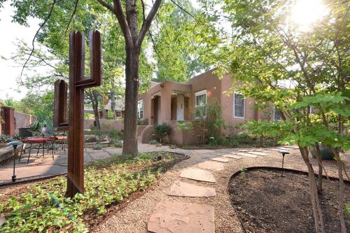 a house with a large cross in the yard at Casa Culinaria - The Gourmet Inn in Santa Fe