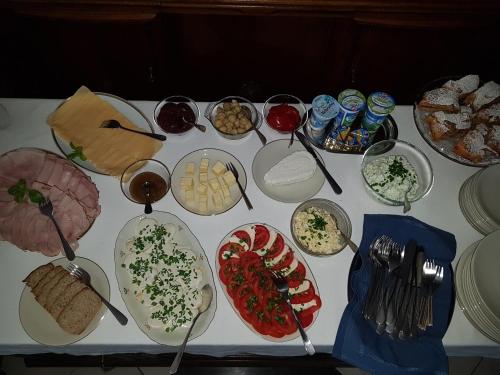 a table topped with plates and bowls of food at Willa Marysin in Maków Podhalański