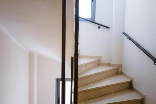 a staircase in a house with a glass railing at Piraeus Port Hotel in Piraeus