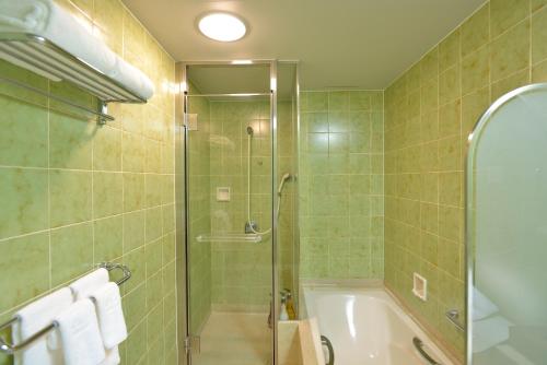 
a bathroom with a shower, sink, and toilet at The Prince Hakone Lake Ashinoko in Hakone
