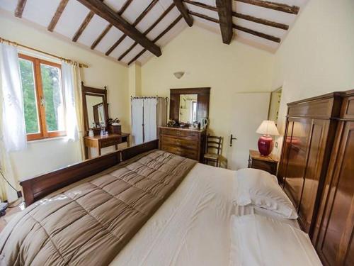 a large bedroom with a large bed and a mirror at B&B Il Giardino in Tavullia
