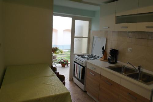 a kitchen with a sink and a stove top oven at Apartment Istriana in Poreč