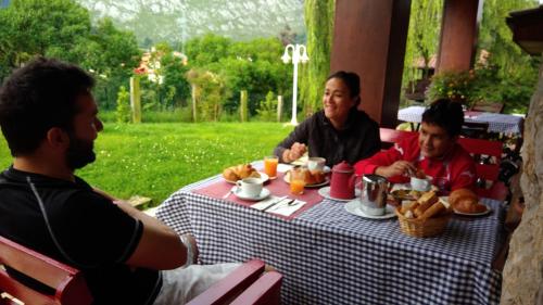 een groep van drie mannen die aan een tafel eten bij La Xana Ribadesella in Ribadesella