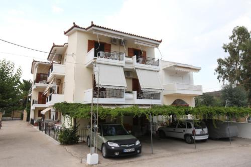 a building with two cars parked in front of it at Sofia Apartments - Kantia in Kandia
