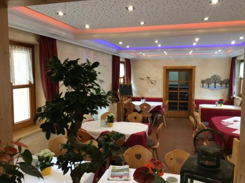 a restaurant with tables and chairs in a room at Golf & Skipension Krug in Haus im Ennstal