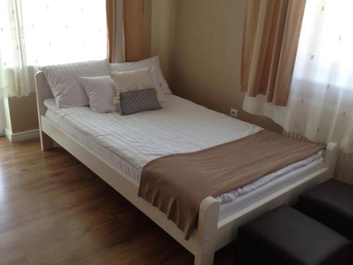 a bed with two pillows on it in a bedroom at Villa Karolina in Mielno
