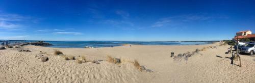 a beach with a car parked on the sand at Villa L'Amiraute in Agde
