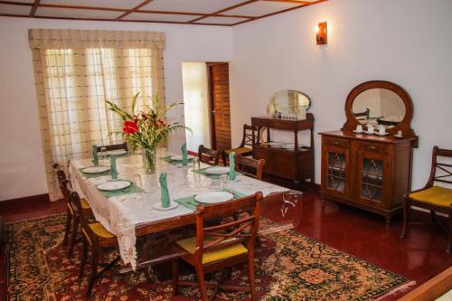 una sala da pranzo con tavolo e sedie di Hatale Mini World's End Bungalow a Madulkele