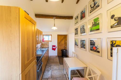 a kitchen with a table and a counter top at Whitley Coach House in Whitley