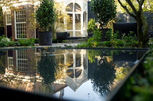 a reflecting pool in the garden of a house at Canal House in Amsterdam