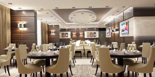 A restaurant or other place to eat at Golden Tulip Doha Hotel