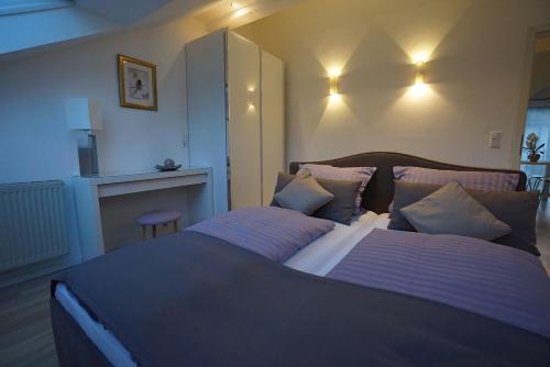 a bedroom with a large bed with two pillows at York Cottage in Traben-Trarbach