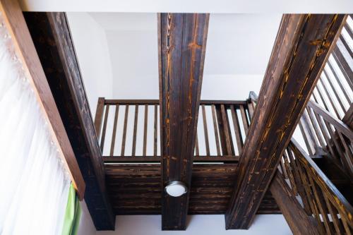 a ceiling in a room with wooden beams at Penzion U Barana in Trojanovice