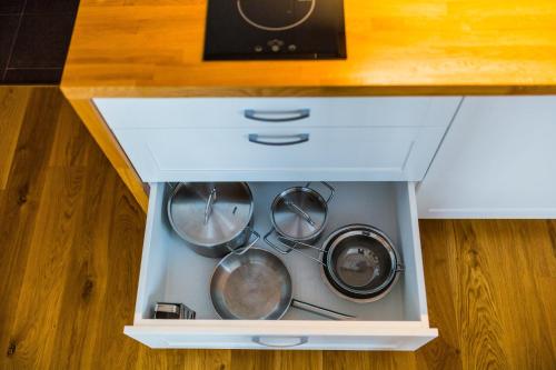 a drawer with pots and pans in a kitchen at Penzion U Barana in Trojanovice