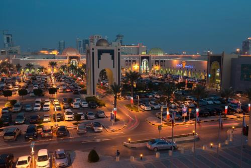 a busy city with cars parked in a parking lot at Fraser Suites Seef Bahrain in Manama