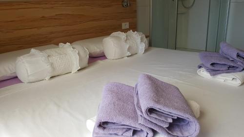 ein Bett mit Handtüchern und Kissen darauf in der Unterkunft Family Home Claudia in Makarska